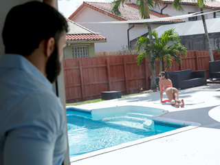 He rubs her pussy and before long has a raging boner. She pulls it out of his pants and sucks on it by the pool before riding his cock on the hammock. Then